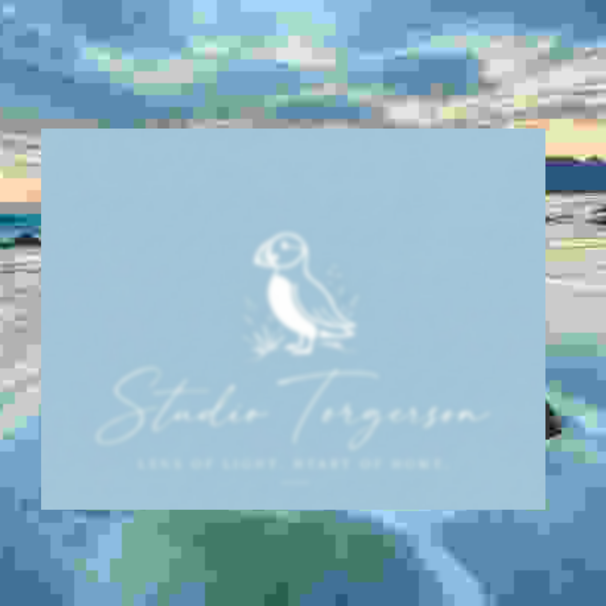 A square light blue card or label with a white puffin illustration and the text 'Studio Torgerson' and 'Lens of Light, Heart of the Bowl' centered on a blurred multicolor background.